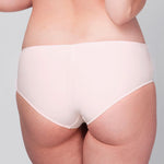Back view of model wearing a Liberté Mid Rise Hipster in blush pink featuringCrosby performance micro jersey and lace insets.
