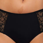 Model wearing a Liberté Crosby Mid Rise Hipster in black, featuring Crosby performance micro jersey and lace insets.