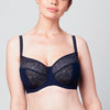 Curve model wearing a midnight blue Liberté Crosby Demi Bra with a 3 piece cup featuring Crosby performance micro jersey on the outside of the cup and lace on the inner cup as well as at the neckline.