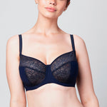Curve model wearing a midnight blue Liberté Crosby Demi Bra with a 3 piece cup featuring Crosby performance micro jersey on the outside of the cup and lace on the inner cup as well as at the neckline.