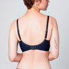 Back view of curve model wearing a midnight blue Liberté Crosby Demi Bra featuring a Crosby performance micro jersey band.