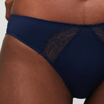 Model wearing a Liberté Crosby Scalloped Cheeky in midnight blue, featuring Crosby performance micro jersey and lace insets.