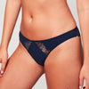 Model wearing a Liberté Crosby Scalloped Cheeky in midnight blue, featuring Crosby performance micro jersey and lace insets.