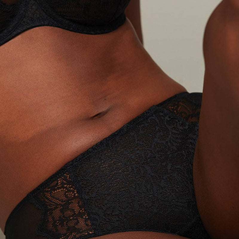 Close up of model wearing a Liberté Bowery Scalloped Hipster, with a semi sheer lace front and sheer mesh sides in black.