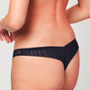 Back view of model wearing a Liberté Bowery Mesh Thong, with a semi sheer mesh back in midnight blue