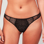 Model wearing a Liberté Bowery Mesh Thong, with a semi sheer lace front and mesh sides in onyx black