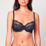 Model wearing Midnight blue Liberté Bowery Lace Demi bra featuring a 3 piece cup and all over sheer lace with scalloped edges. 