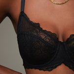 Model wearing a black Liberté Bowery Lace Demi bra featuring a 3 piece cup and all over sheer lace with scalloped edges.