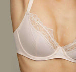 Model wearing a blush pink Liberté Crosby Plunge Bra with Crosby performance micro jersey on the bottom cup and lace with scalloped edges on the top cup.